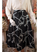 Black midi skirt with white bows and chain print