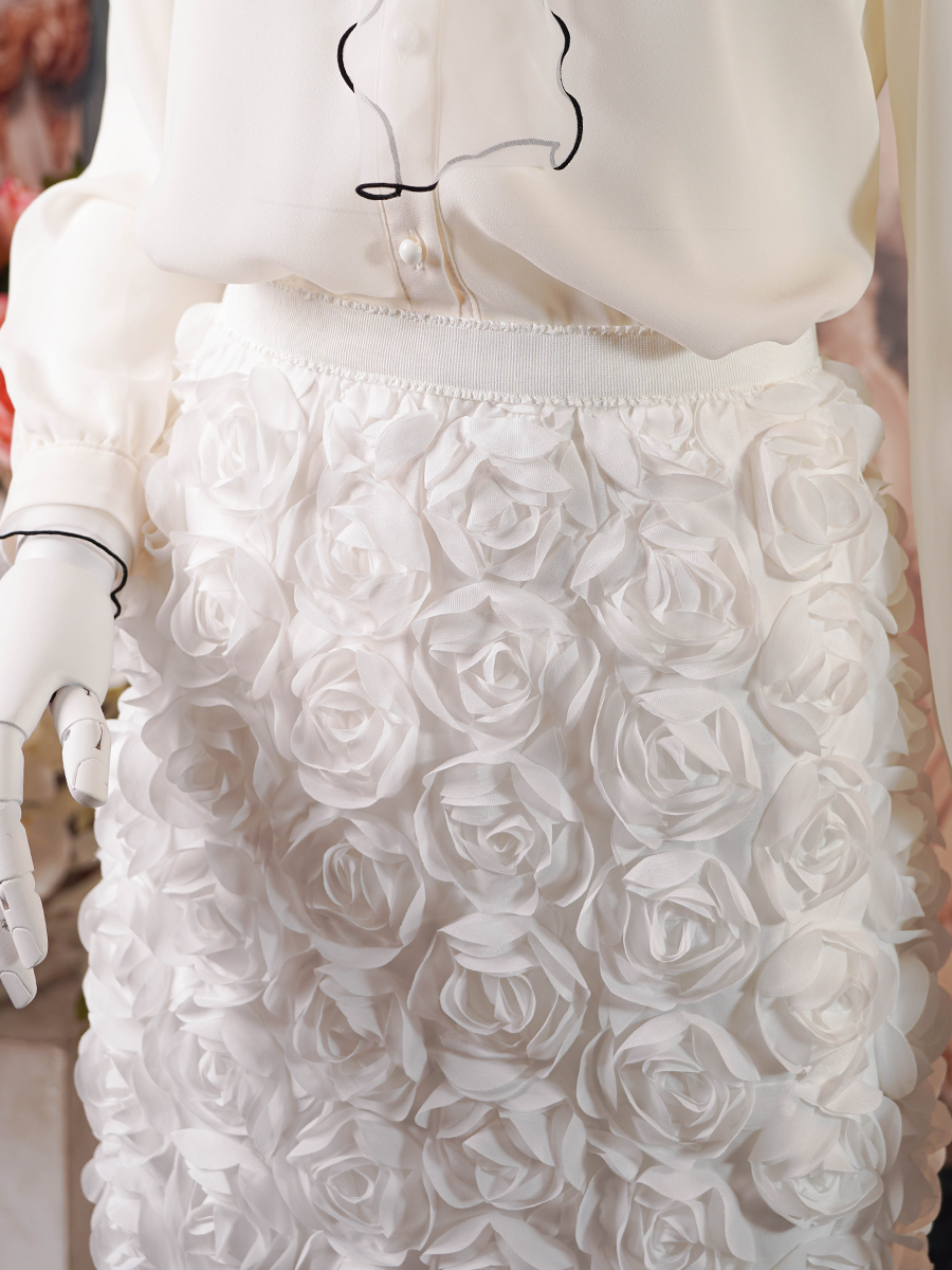 White midi skirt covered in 3D rose appliqués