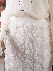 White midi skirt covered in 3D rose appliqués