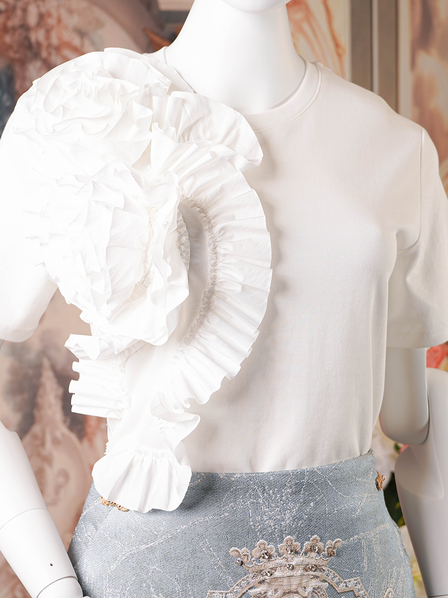 White t-shirt with a large white ruffle detail on one shoulder