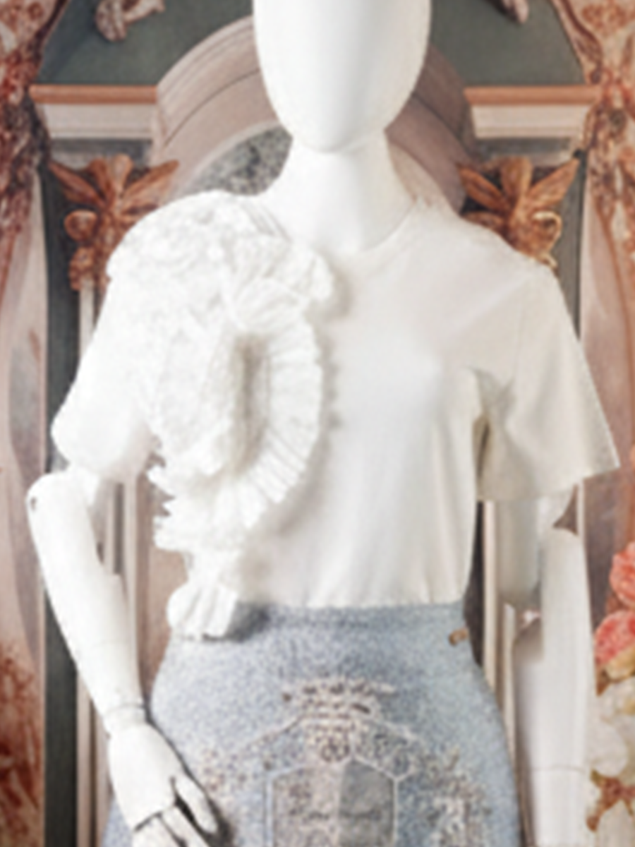 White t-shirt with a large white ruffle detail on one shoulder